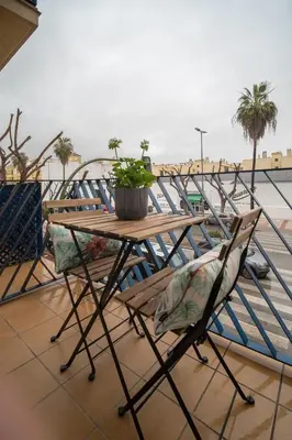 a table and chairs on top of a balcony at Apartamento Centro&Playa Sanlucar - V Centenario in Sanlúcar de Barrameda
