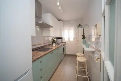 a white kitchen with a sink and a counter at Apartamento Centro&Playa Sanlucar - V Centenario in Sanlúcar de Barrameda