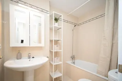 a bathroom with a sink and a mirror and a tub at Apartamento Centro Sanlucar - Banda Playa in Sanlúcar de Barrameda
