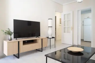 a living room with a flat screen tv on a wooden entertainment center at Apartamento Centro Sanlucar - Banda Playa in Sanlúcar de Barrameda