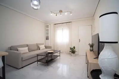 a living room with a couch and a table at Apartamento Centro Sanlucar - Banda Playa in Sanlúcar de Barrameda