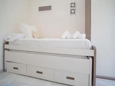 a bed with white sheets and pillows on it at SibsSanlucar Calma - Centro y Playa - Nuevo in Sanlúcar de Barrameda