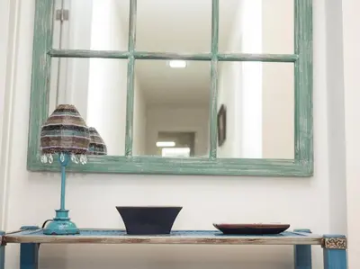 a mirror and a table with a lamp on it at SibsSanlucar Calma - Centro y Playa - Nuevo in Sanlúcar de Barrameda