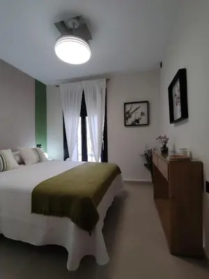 a bedroom with a large bed and a window at Luxe Apartamento Duque de Alta in Arcos de la Frontera