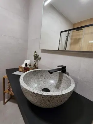 a bathroom with a large stone sink on a counter at Luxe Apartamento Duque de Alta in Arcos de la Frontera