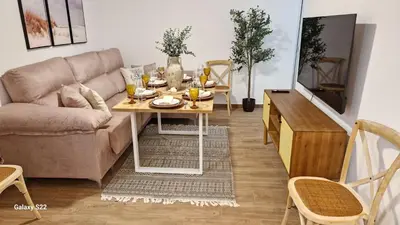 a living room with a couch and a table at MANZANILLA CENTRO PLAYA in Sanlúcar de Barrameda