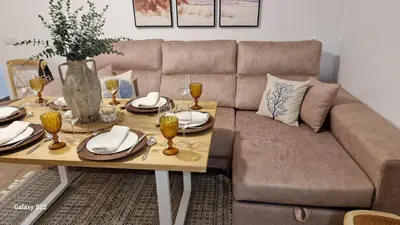 a living room with a couch and a table with wine glasses at MANZANILLA CENTRO PLAYA in Sanlúcar de Barrameda
