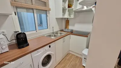 a kitchen with a sink and a washing machine at MANZANILLA CENTRO PLAYA in Sanlúcar de Barrameda