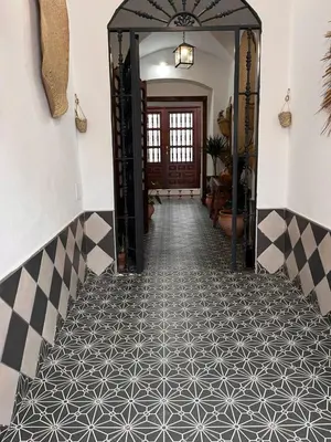 a hallway with a black and white tile floor at El Patio de María in Bornos