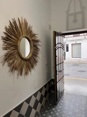 a mirror on a wall next to a hallway at El Patio de María in Bornos