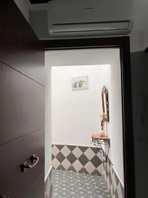 a bathroom door with a checkered floor at El Patio de María in Bornos