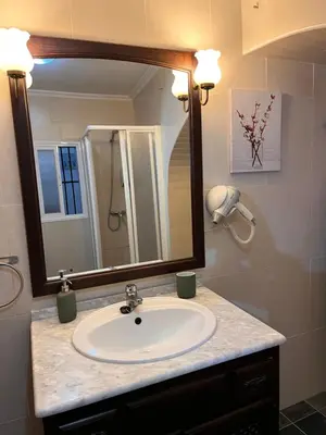 a bathroom with a sink and a mirror at El Patio de María in Bornos