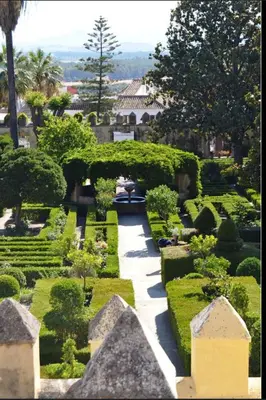 a garden with bushes and a walkway at El Patio de María in Bornos