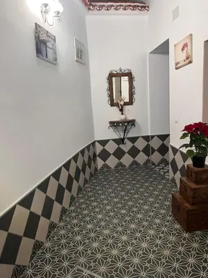 a bathroom with a staircase with a sink and a mirror at El Patio de María in Bornos