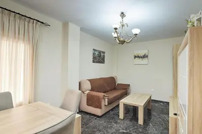 a living room with a couch and a table at Gades Zuloaga Ha in Cádiz