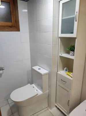 a white bathroom with a toilet and a sink at EA bahía sur in San Fernando