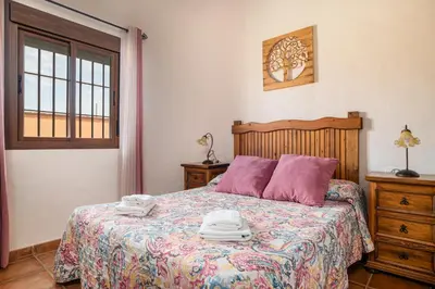 a bedroom with a bed with towels on it at Villa Marta Clara in Conil de la Frontera
