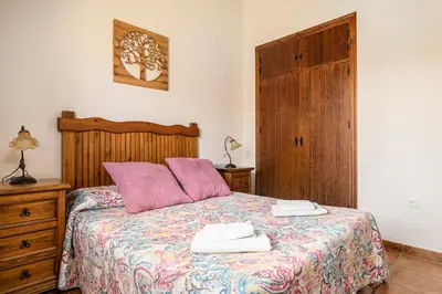a bedroom with a bed with two towels on it at Villa Marta Clara in Conil de la Frontera