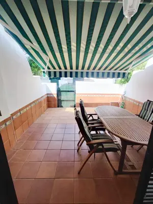 a patio with a table and chairs and a ceiling at Apartamento en Chiclana de la Frontera in Chiclana de la Frontera