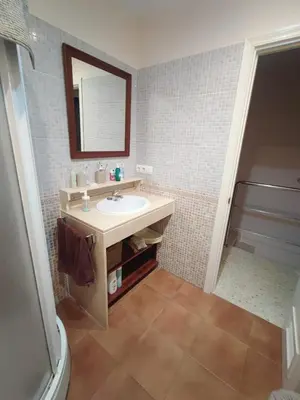 a bathroom with a sink and a mirror at Apartamento en Chiclana de la Frontera in Chiclana de la Frontera