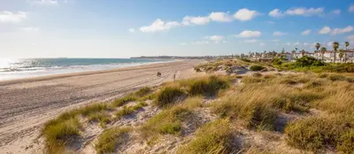 a person walking on a beach near the ocean at Apartamento en Chiclana de la Frontera in Chiclana de la Frontera