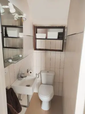 a small bathroom with a toilet and a sink at Apartamento en Chiclana de la Frontera in Chiclana de la Frontera