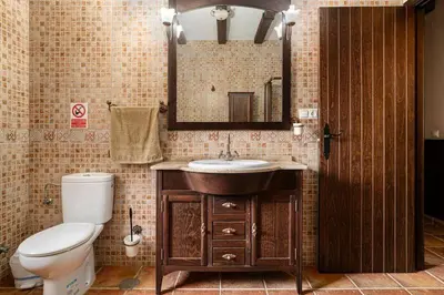 a bathroom with a toilet and a sink and a mirror at Casa Cala Puntalejo in Conil de la Frontera