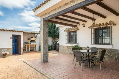 an outdoor patio with a table and chairs at Casa Cala Puntalejo in Conil de la Frontera
