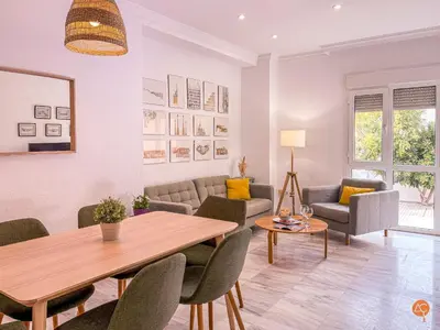 a living room with a table and chairs at El Pelícano Parking free Grupo Ac Gestion in Cádiz