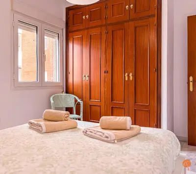 a bedroom with a bed with two towels on it at El Pelícano Parking free Grupo Ac Gestion in Cádiz