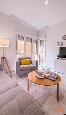 a living room with a couch and a table at El Pelícano Parking free Grupo Ac Gestion in Cádiz