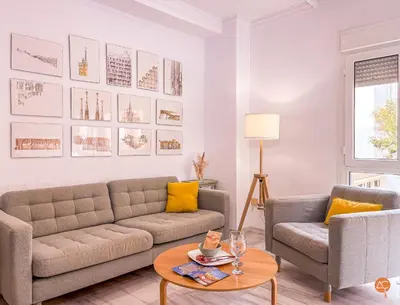 a living room with a couch and a table at El Pelícano Parking free Grupo Ac Gestion in Cádiz