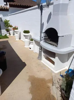 a patio with a pizza oven on the side of a building at Villa completa con piscina en Arcos de la frontera in Arcos de la Frontera