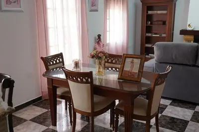 a living room with a wooden table and chairs at Villa completa con piscina en Arcos de la frontera in Arcos de la Frontera