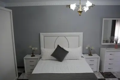 a bedroom with a white bed with two night stands at Villa completa con piscina en Arcos de la frontera in Arcos de la Frontera