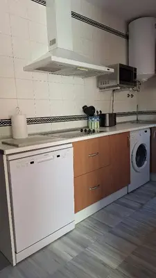 a kitchen with a washing machine and a washer at La Serena, Unifamiliar adosada en La Barrosa in Chiclana de la Frontera