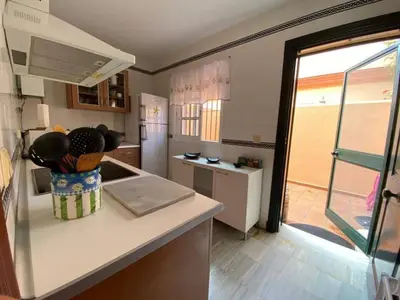 a kitchen with a counter with a vase on it at La Serena, Unifamiliar adosada en La Barrosa in Chiclana de la Frontera