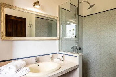 a bathroom with a sink and a mirror and a shower at Paraiso Perdido in Conil de la Frontera