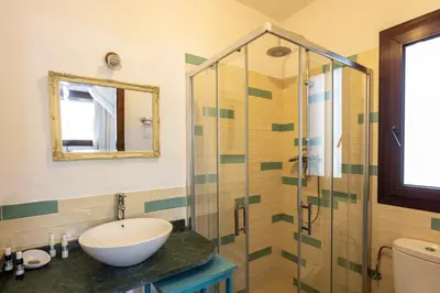 a bathroom with a sink and a glass shower at Paraiso Perdido in Conil de la Frontera