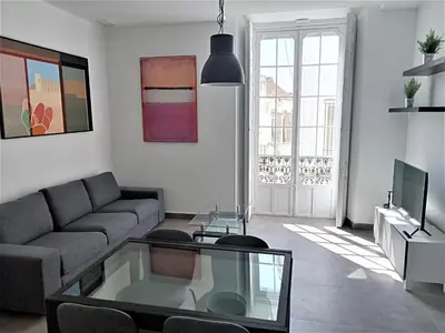 a living room with a couch and a glass table at El Anfitrión Palacio Argüeso 12 in Sanlúcar de Barrameda