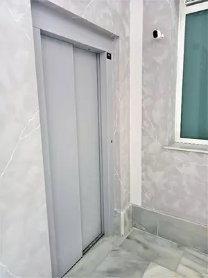 a white door in a room with a window at El Anfitrión Palacio Argüeso 12 in Sanlúcar de Barrameda