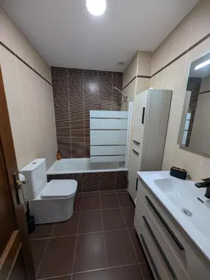 a bathroom with a toilet and a tub and a sink at Casa Brake in Chiclana de la Frontera