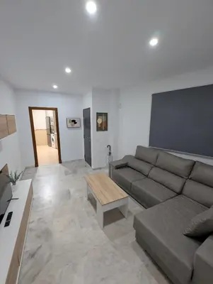 a living room with a couch and a coffee table at Casa Brake in Chiclana de la Frontera