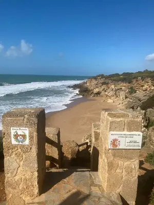 a view of a beach with a fence and the ocean at Mas del Cullou, moderne Villa in Andalusien, in der Nähe vom Meer in Cádiz