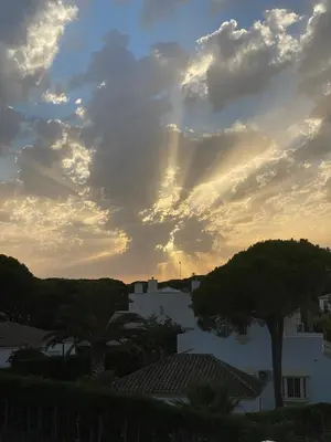 a cloudy sky with trees and buildings in a city at Mas del Cullou, moderne Villa in Andalusien, in der Nähe vom Meer in Cádiz