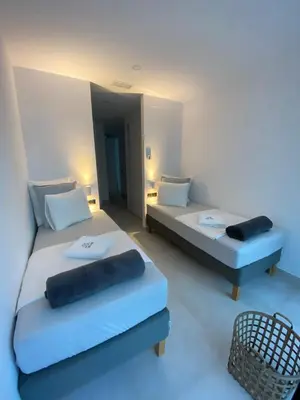 a room with two beds and a chair at Mas del Cullou, moderne Villa in Andalusien, in der Nähe vom Meer in Cádiz