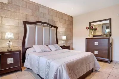 a bedroom with a large bed and a mirror at Casa Borpa - Solo Familias in Conil de la Frontera