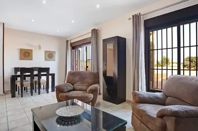 a living room with a couch and chairs and a table at Casa Borpa - Solo Familias in Conil de la Frontera