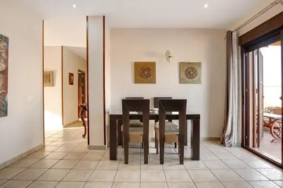 a dining room with a table and chairs at Casa Borpa - Solo Familias in Conil de la Frontera