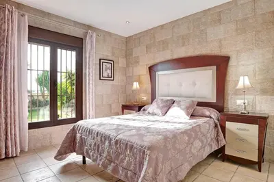 a bedroom with a large bed and a window at Casa Borpa - Solo Familias in Conil de la Frontera